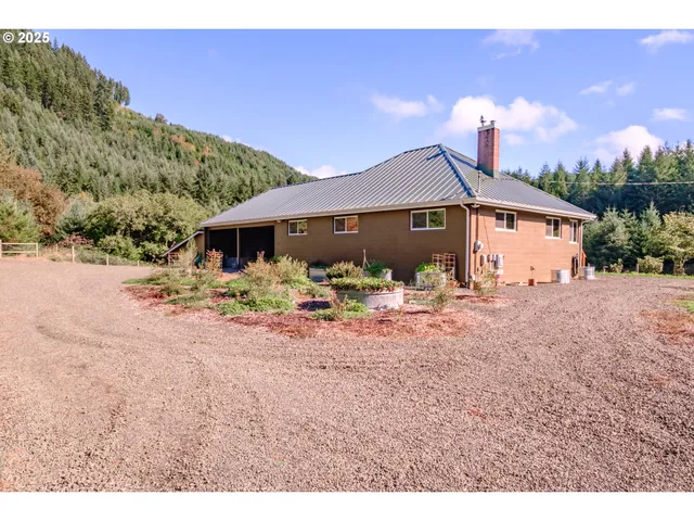 a front view of a house with a yard and mountain