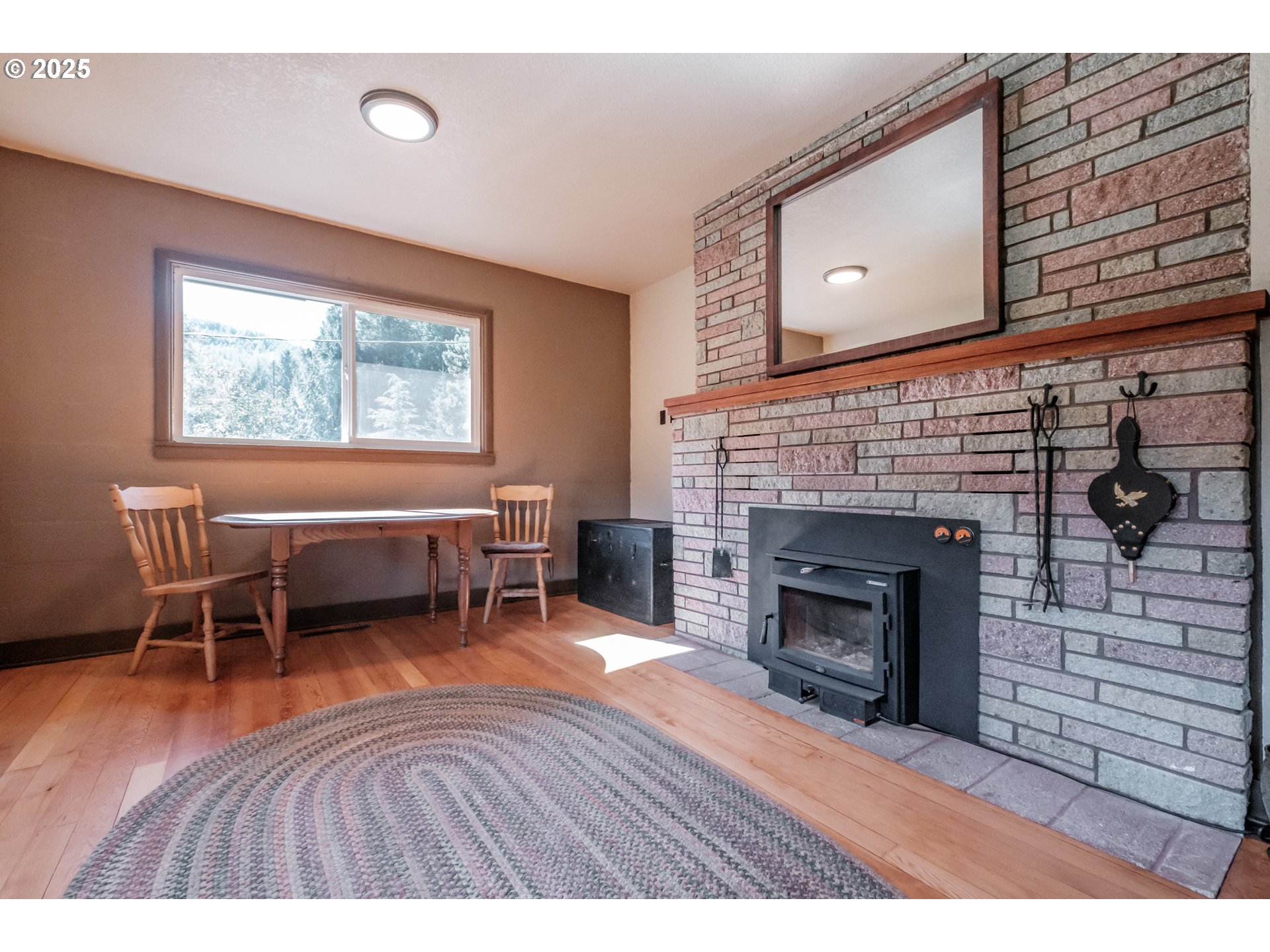 9602 Harlan Road Eddyville, OR 97343 - Photo 9 of 48 a living room with furniture and a fireplace