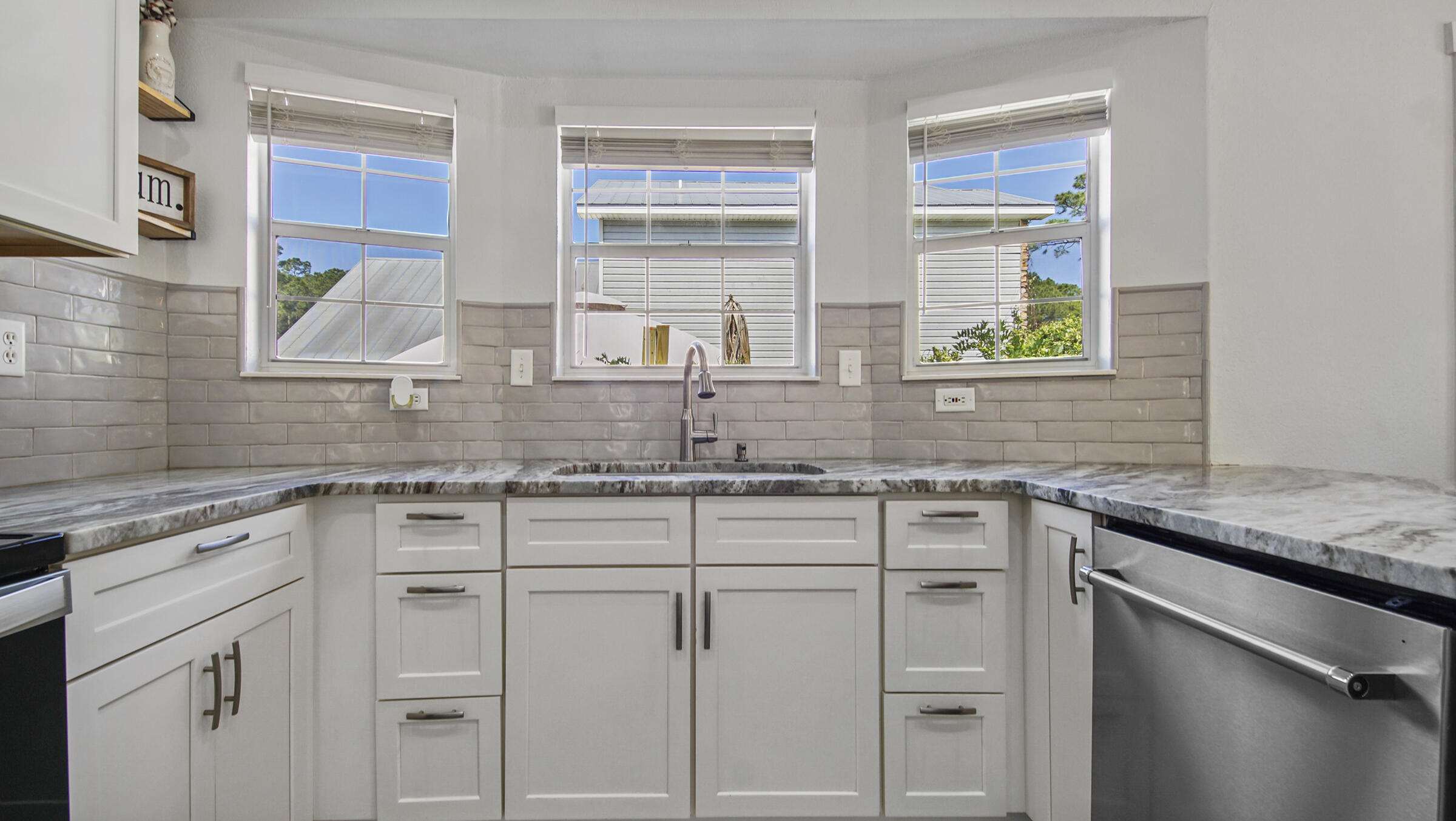 190 Plantation Way Santa Rosa Beach, FL 32459 - Photo 21 of 41 a kitchen with white cabinets and a window