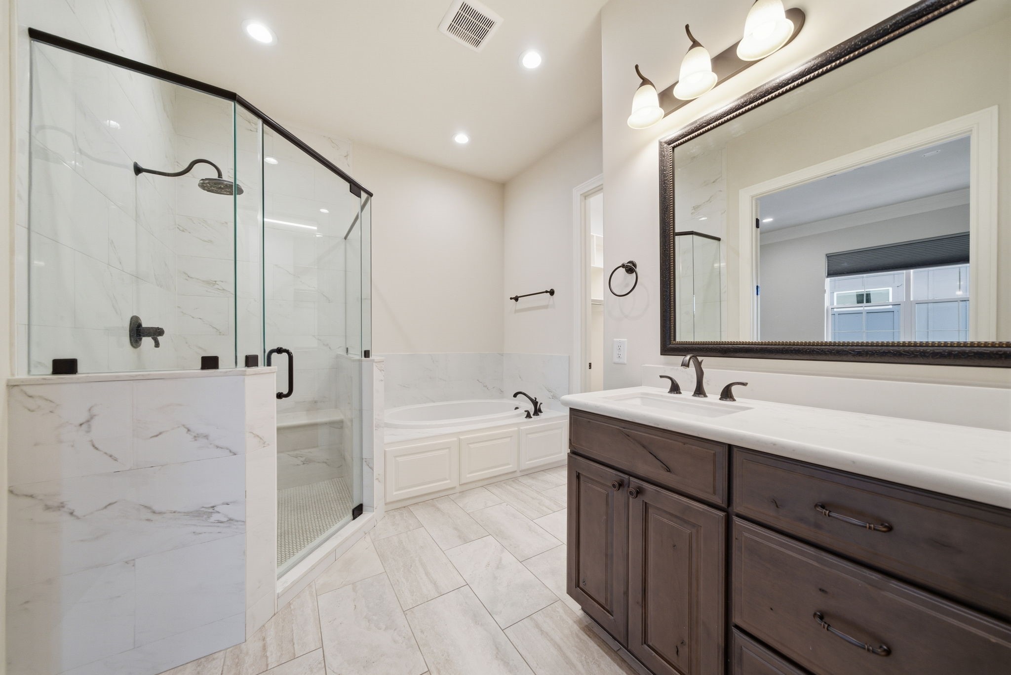 4224 Gibson Street Houston, TX 77007 - Photo 13 of 22 a bathroom with a tub sink double vanity granite tub shower and mirror