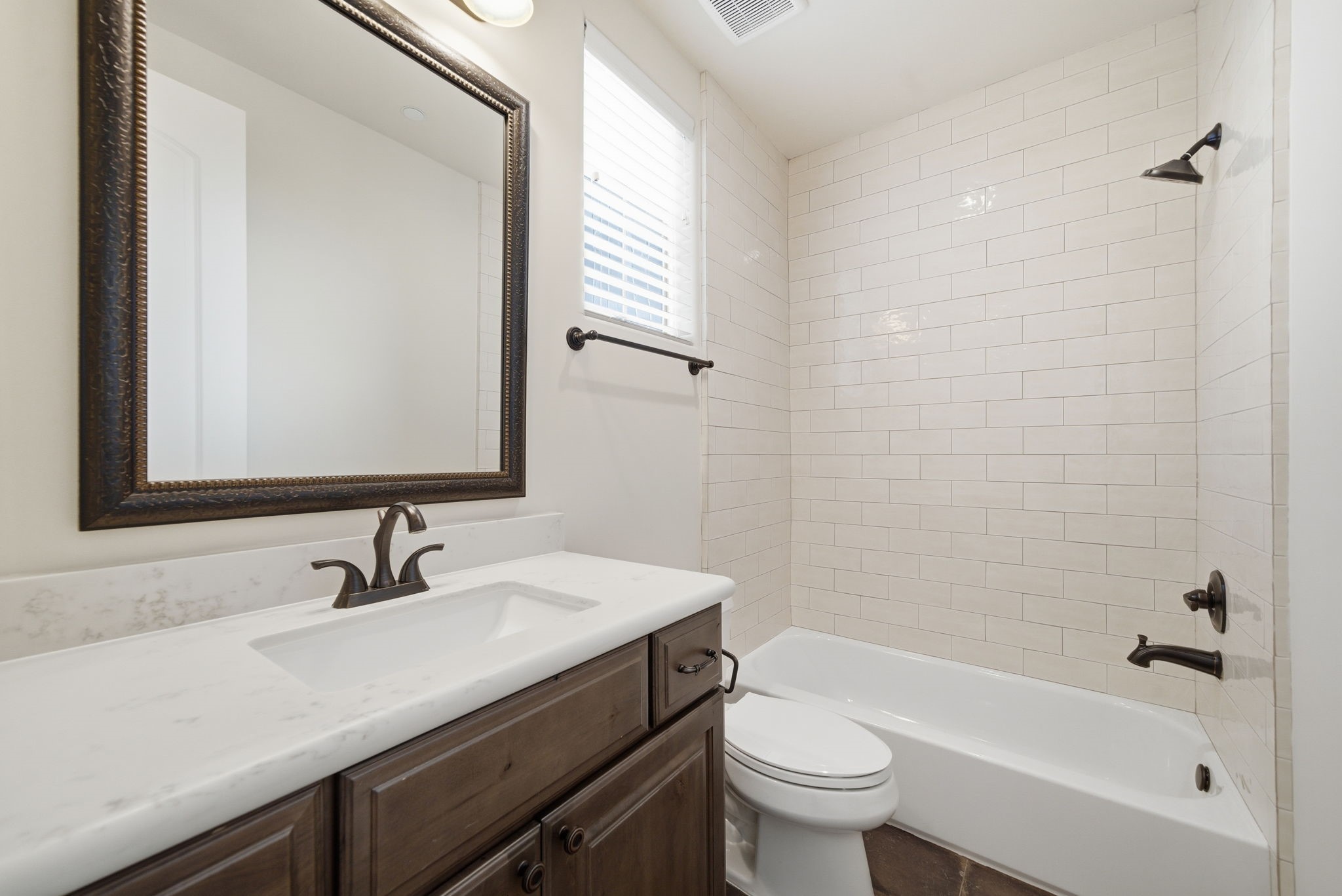 4224 Gibson Street Houston, TX 77007 - Photo 15 of 22 a bathroom with a sink a toilet a mirror and shower
