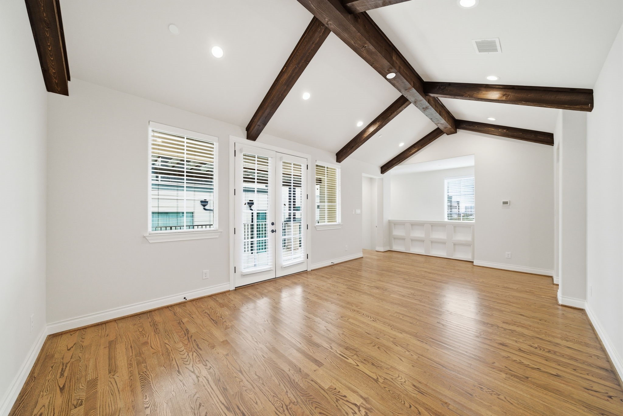 4224 Gibson Street Houston, TX 77007 - Photo 16 of 22 a view of an empty room with wooden floor and a window