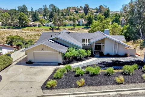 a aerial view of a house next to a yard