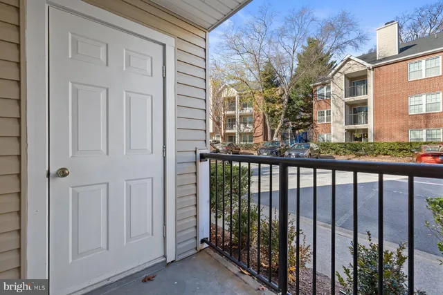 a porch with a table and chairs