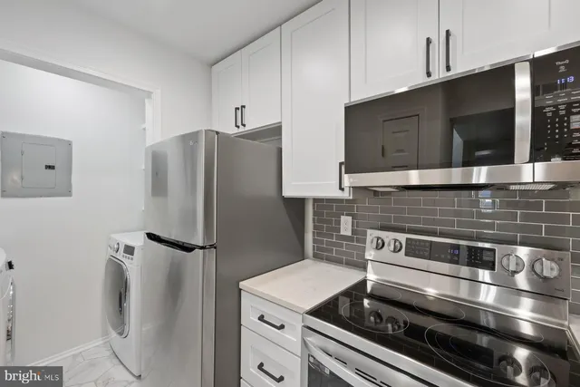 a kitchen with a stove and a microwave