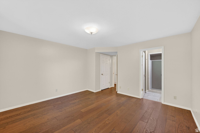 3120 North Apache Way Provo, UT 84604 - Photo 33 of 58 Spacious room featuring wood-finish flooring, light neutral wall tones, and a flush-mount ceiling light