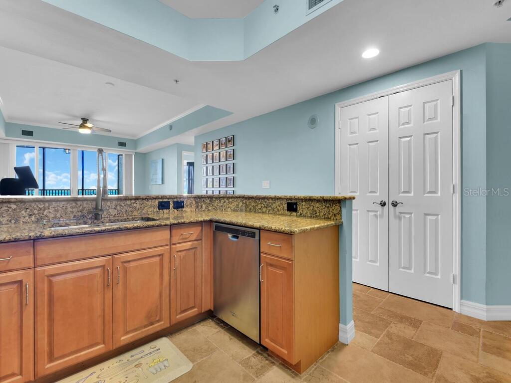 2797 First Street, Unit 1605 Fort Myers, FL 33916 - Photo 11 of 38 a kitchen with granite countertop a sink and cabinets
