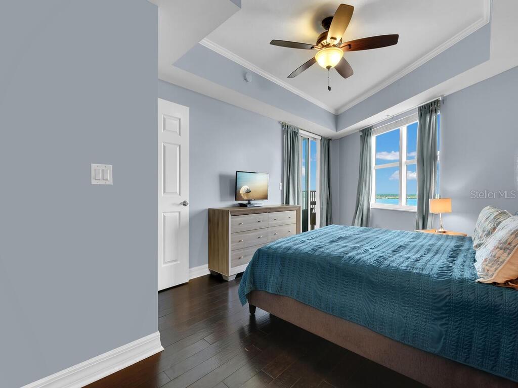 2797 First Street, Unit 1605 Fort Myers, FL 33916 - Photo 17 of 38 a bedroom with a bed and a ceiling fan