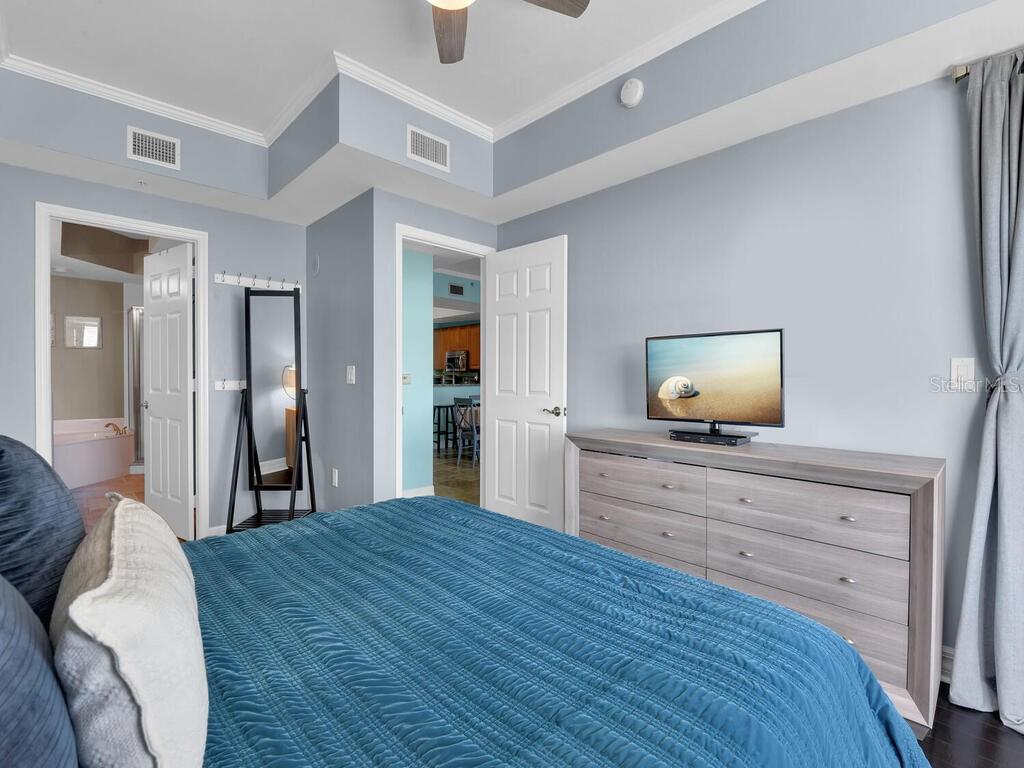2797 First Street, Unit 1605 Fort Myers, FL 33916 - Photo 18 of 38 a bedroom with a bed and a flat screen tv