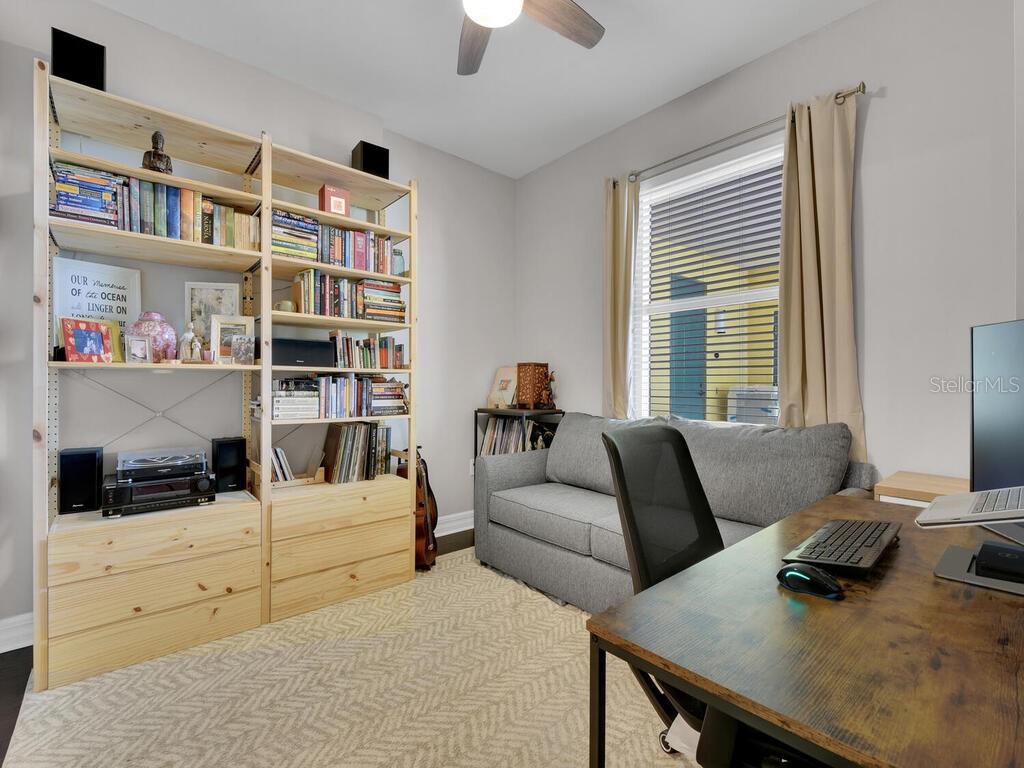 2797 First Street, Unit 1605 Fort Myers, FL 33916 - Photo 20 of 38 a living room with furniture and a book shelf