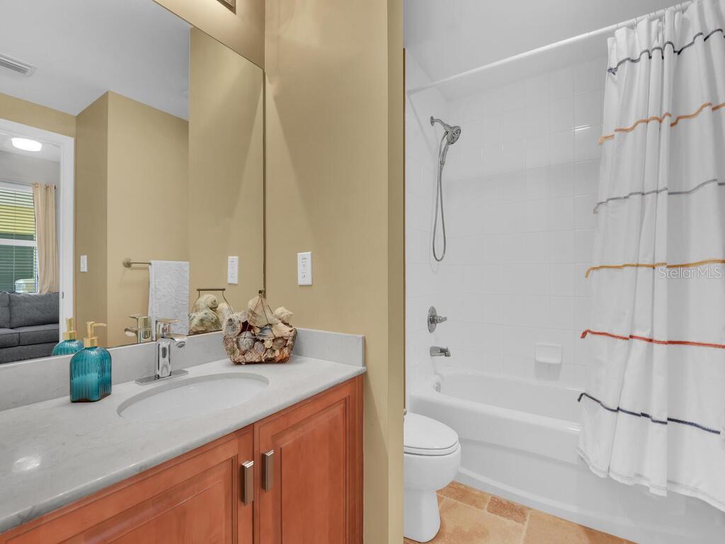 2797 First Street, Unit 1605 Fort Myers, FL 33916 - Photo 22 of 38 a bathroom with a granite countertop sink a toilet and shower