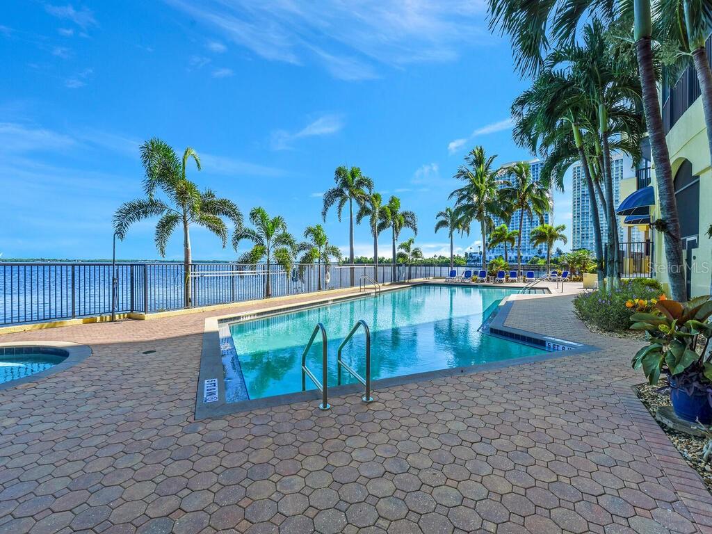 2797 First Street, Unit 1605 Fort Myers, FL 33916 - Photo 31 of 38 a view of swimming pool with a table and chairs