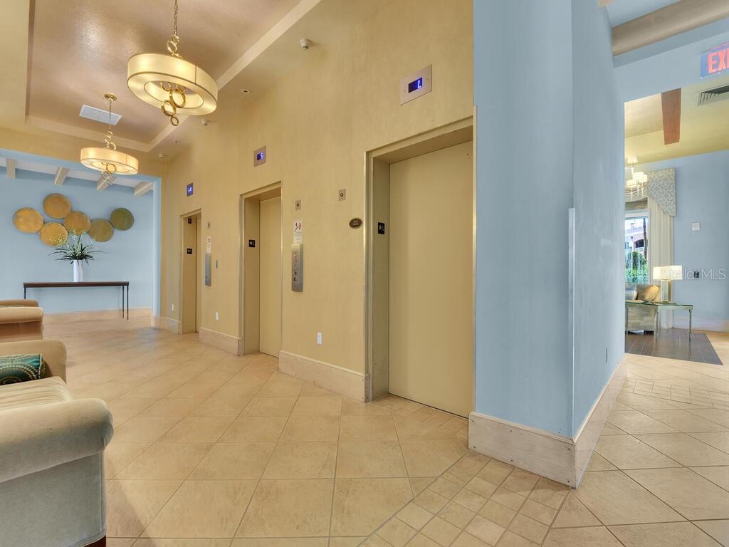 2797 First Street, Unit 1605 Fort Myers, FL 33916 - Photo 37 of 38 a view of a livingroom with a chandelier furniture and kitchen view