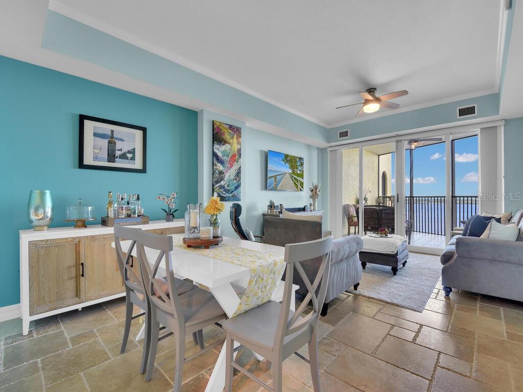 2797 First Street, Unit 1605 Fort Myers, FL 33916 - Photo 6 of 38 a view of a dining room with furniture large windows and wooden floor