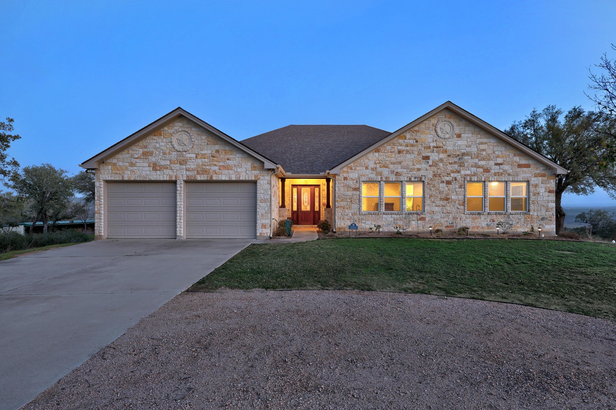 28701 Valley Road Marble Falls, TX 78654 - Photo 35 of 35 a front view of a house with a yard and garage