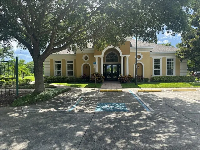 a front view of a house with a yard and trees