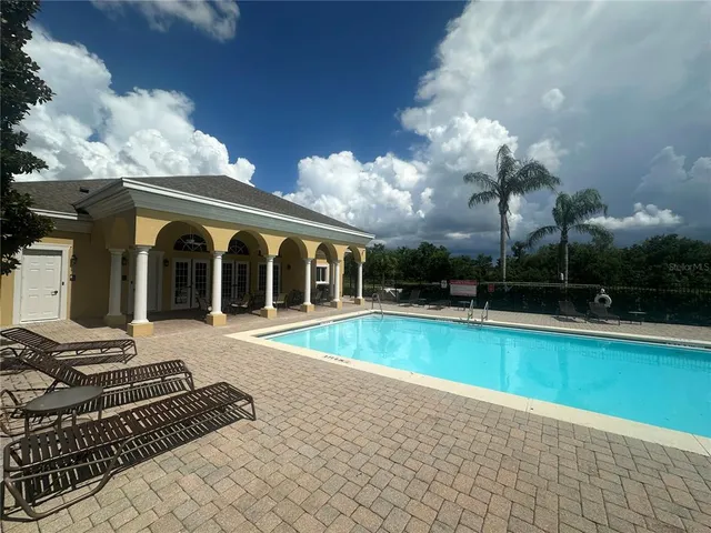 a view of a house with backyard and sitting area