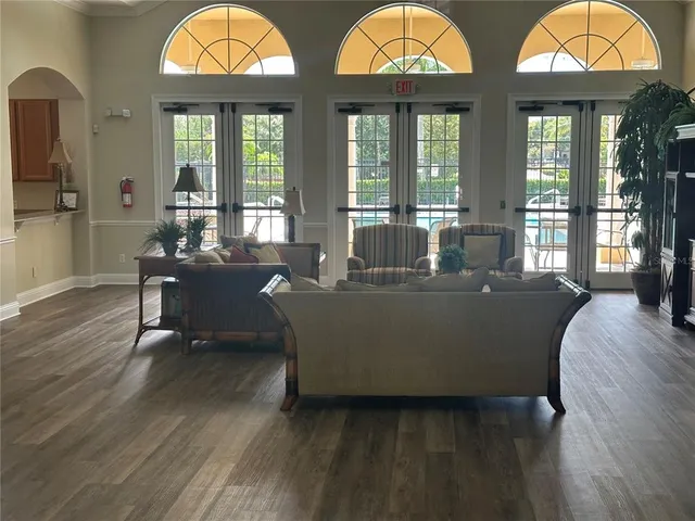 a living room with furniture a fireplace and windows