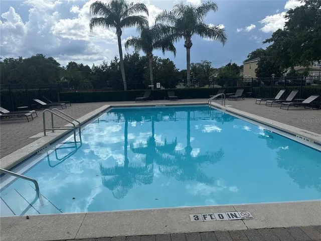 a view of a swimming pool with a yard