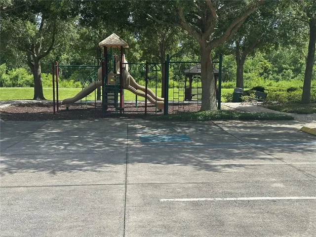 a view of a park with swings and slides