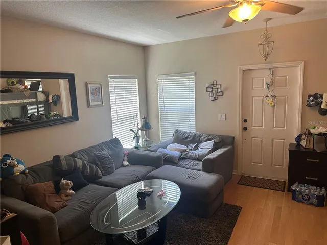 a living room with furniture a lamp and a window