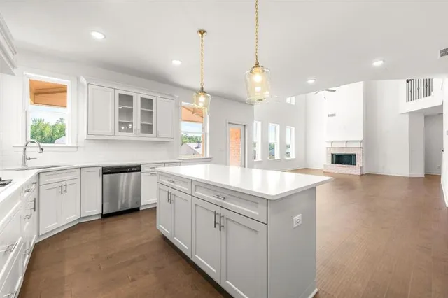 a kitchen with a sink window and cabinets