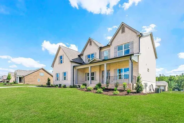 a front view of a house with a yard and garage