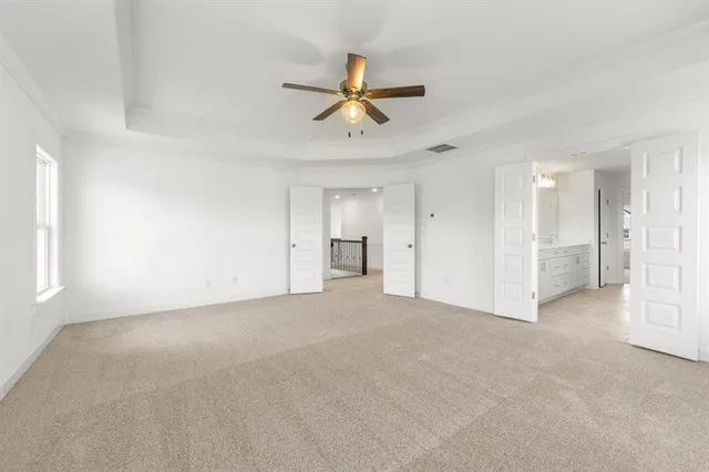 a view of a livingroom with a ceiling fan and window