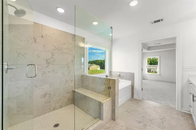 a bathroom with a bathtub and a shower