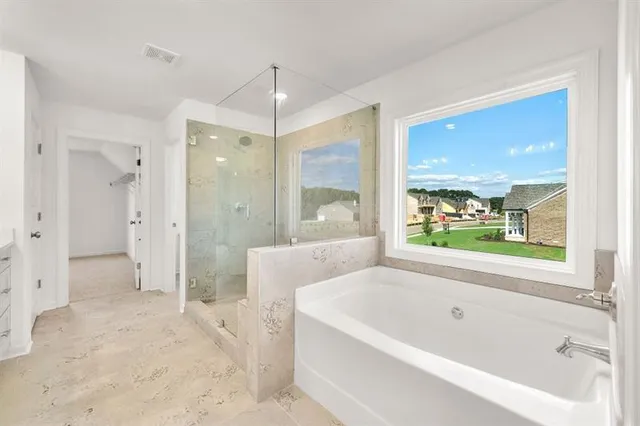 a bathroom with a bathtub and a shower