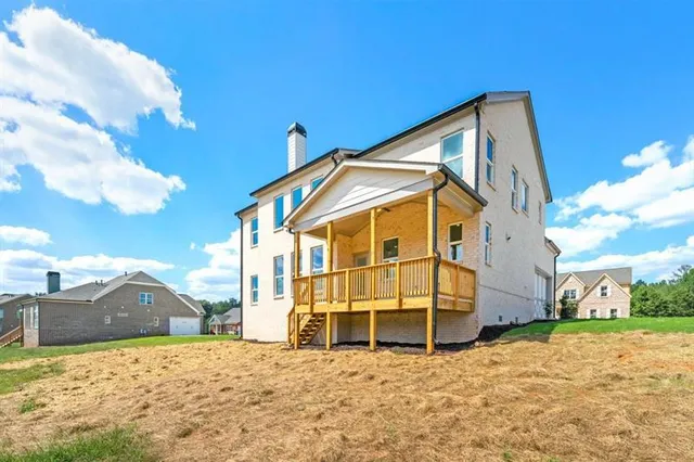 a view of a house with wooden fence