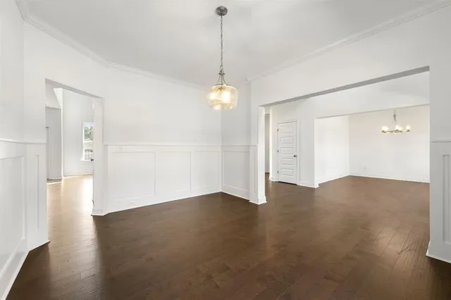a view of a room with wooden floor and windows