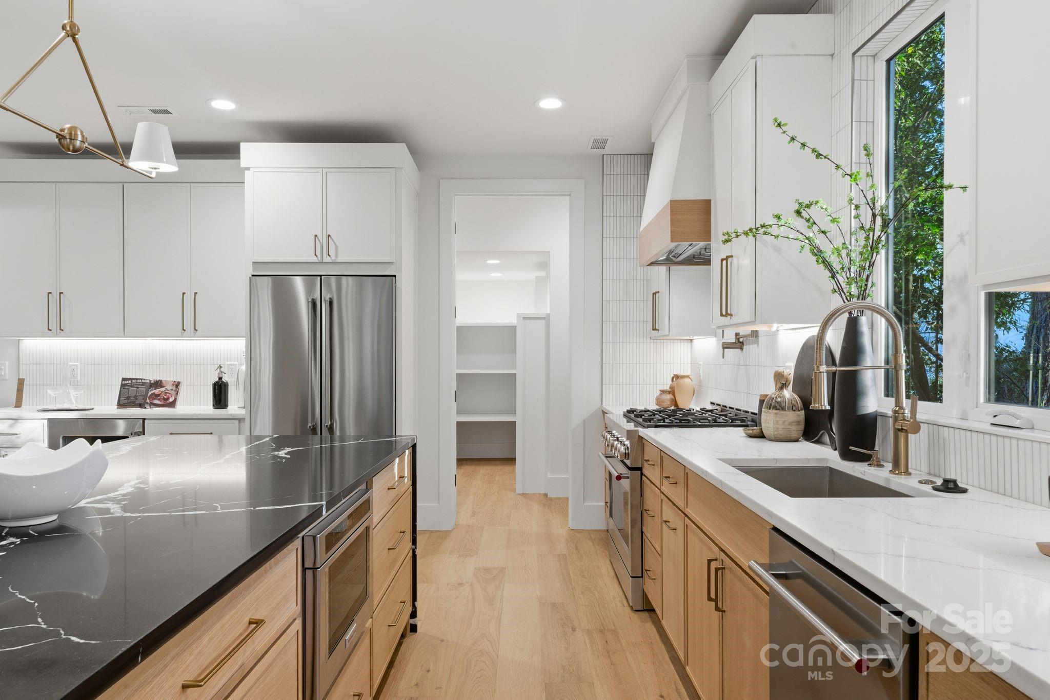 4658 Murrayhill Road Charlotte, NC 28209 - Photo 14 of 48 a kitchen with kitchen island granite countertop a sink a counter and stainless steel appliances
