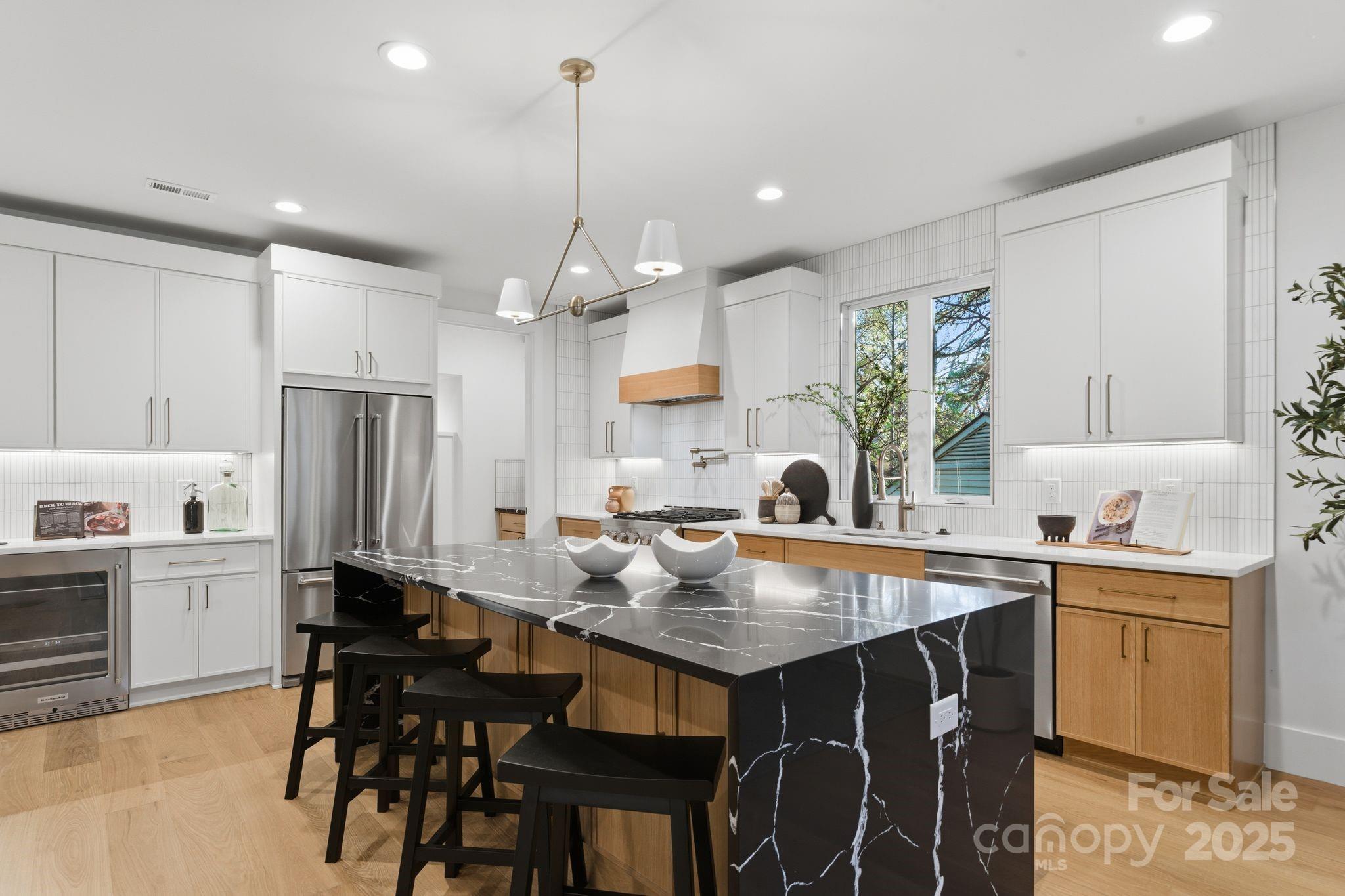 4658 Murrayhill Road Charlotte, NC 28209 - Photo 15 of 48 a kitchen with stainless steel appliances kitchen island granite countertop a table chairs sink and cabinets