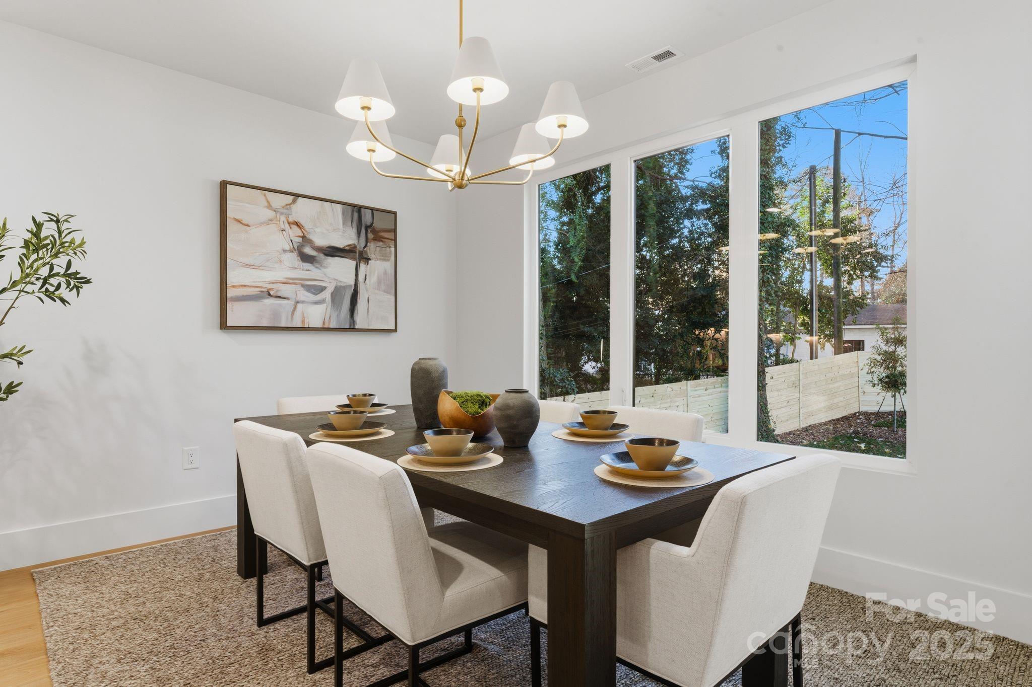 4658 Murrayhill Road Charlotte, NC 28209 - Photo 18 of 48 a view of a dining room with furniture wooden floor and a chandelier