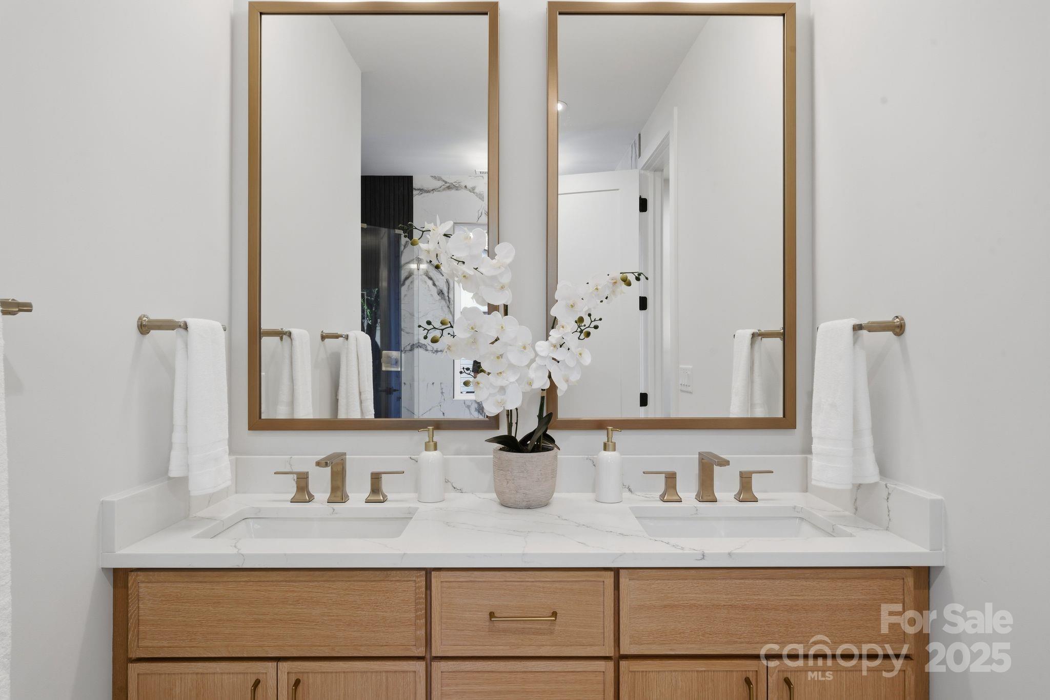 4658 Murrayhill Road Charlotte, NC 28209 - Photo 23 of 48 a bathroom with cabinets and mirror