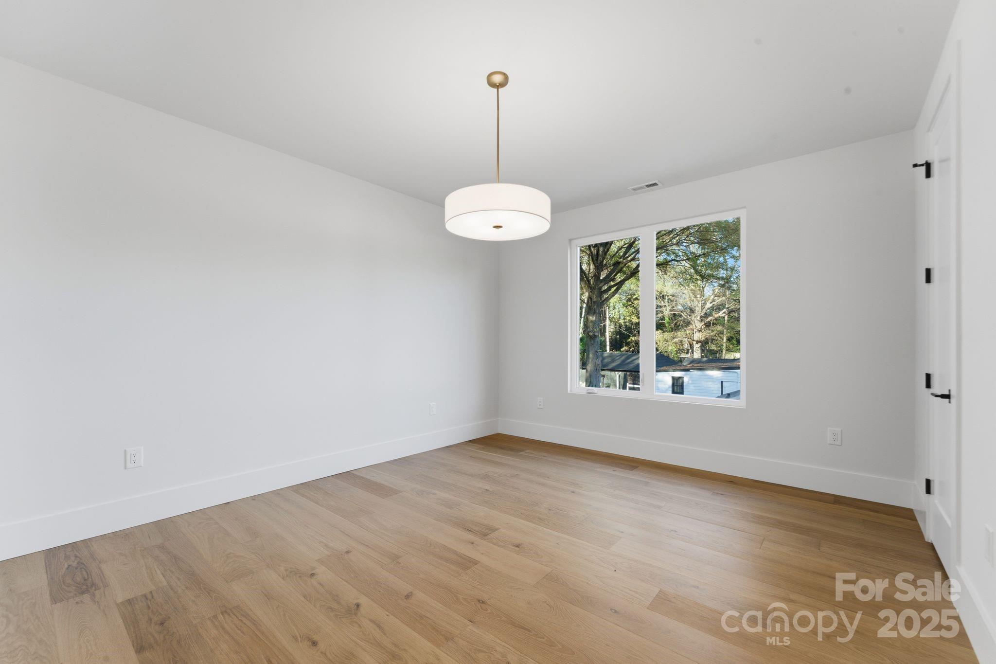 4658 Murrayhill Road Charlotte, NC 28209 - Photo 31 of 48 wooden floor in an empty room with a window