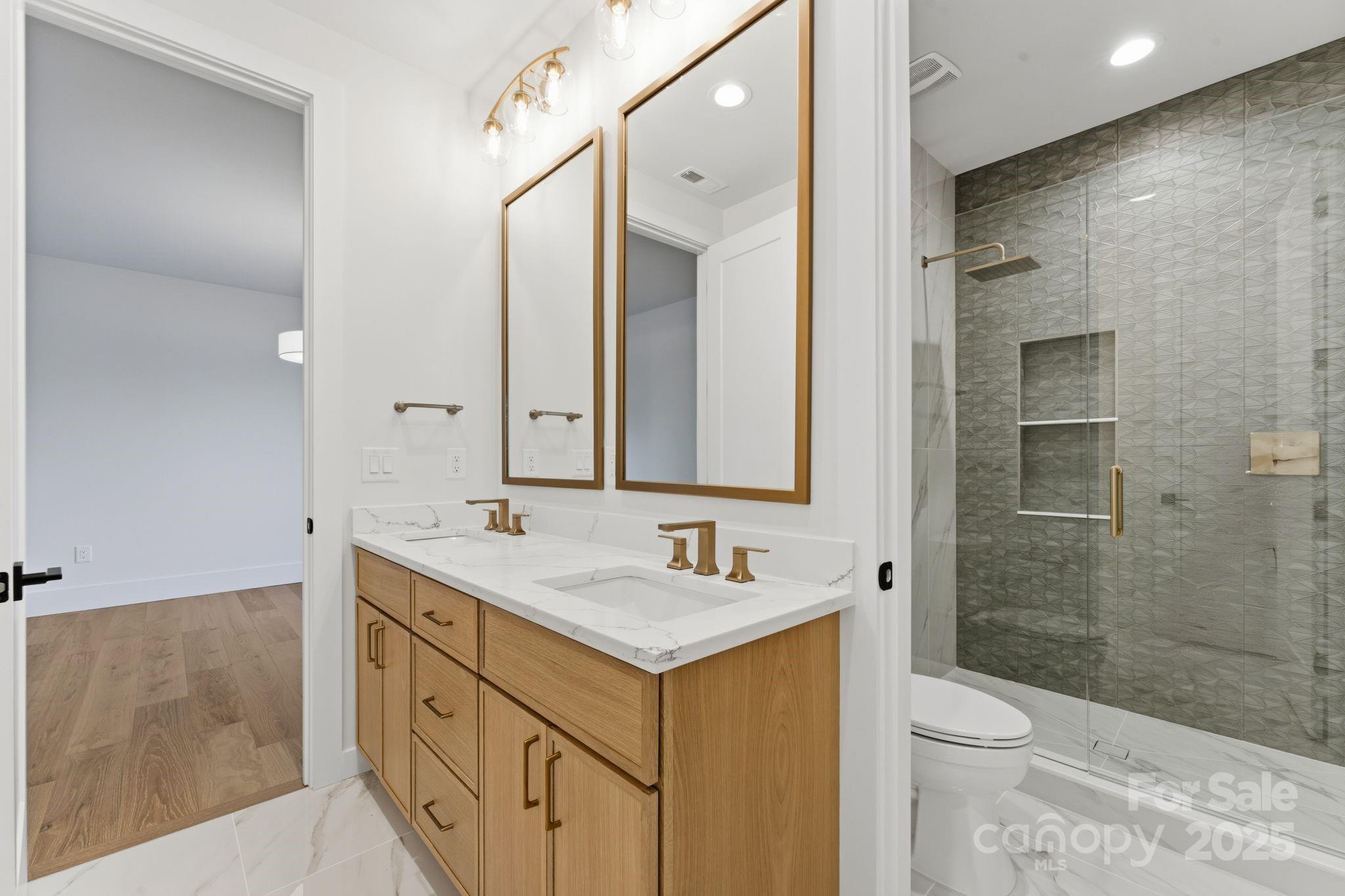 4658 Murrayhill Road Charlotte, NC 28209 - Photo 32 of 48 a bathroom with a sink a toilet and shower