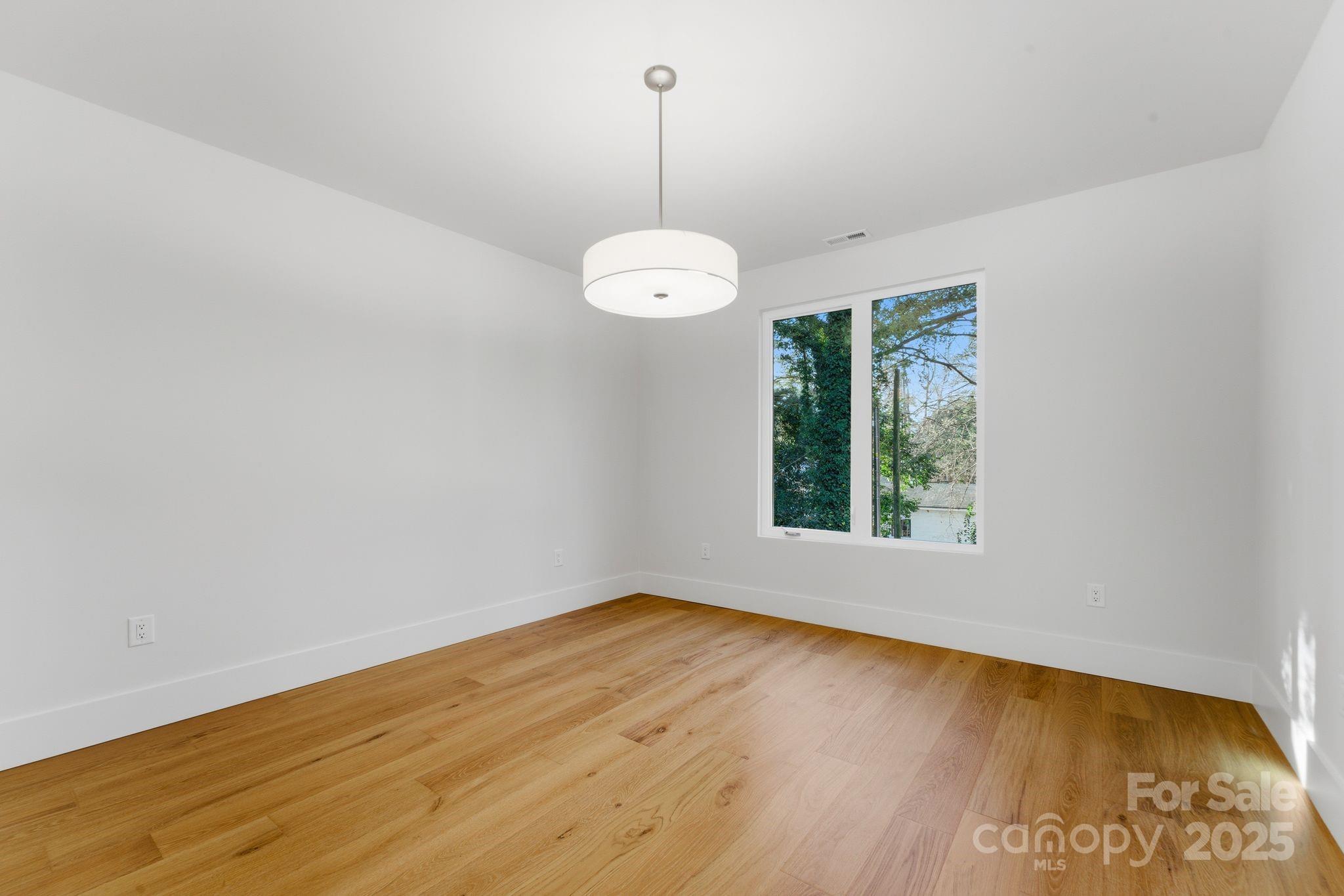 4658 Murrayhill Road Charlotte, NC 28209 - Photo 33 of 48 an empty room with wooden floor and windows