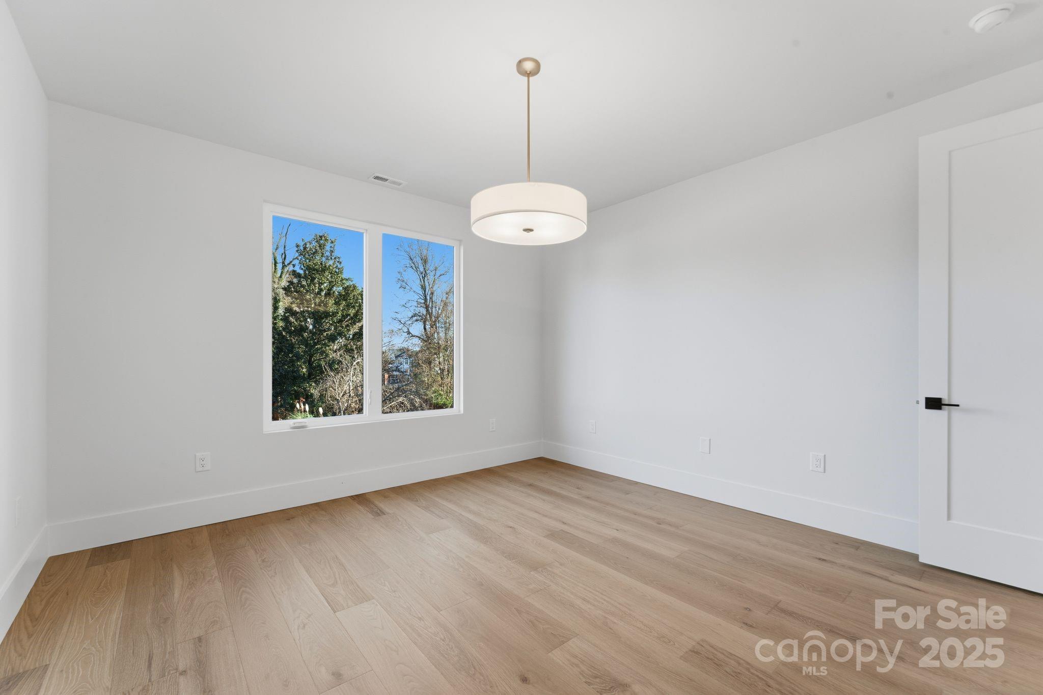 4658 Murrayhill Road Charlotte, NC 28209 - Photo 34 of 48 a view of a room with wooden floor and windows