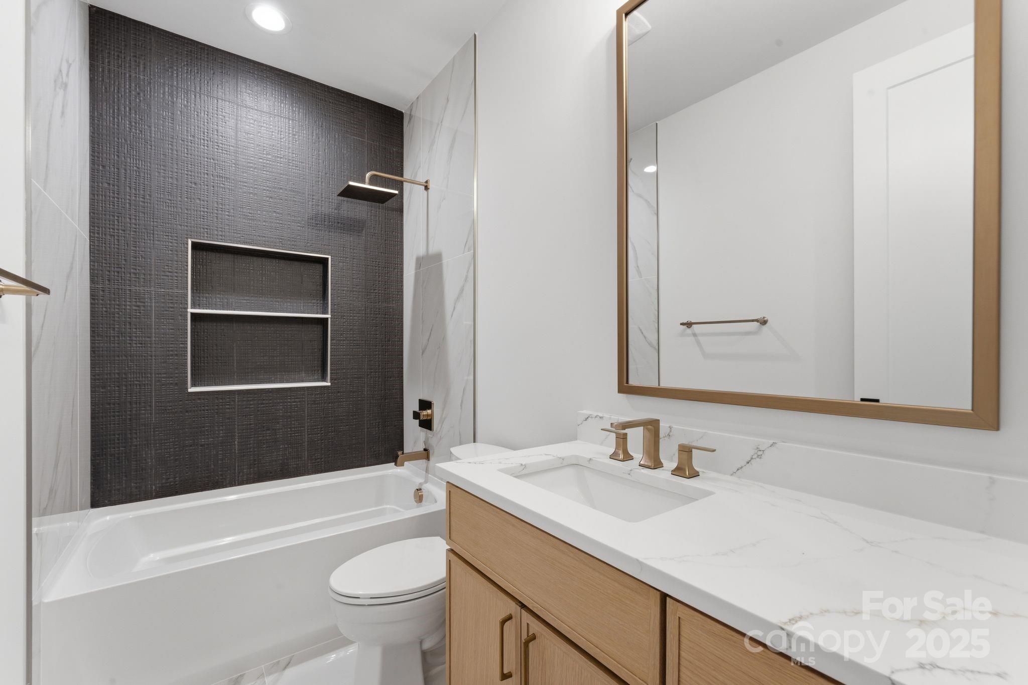4658 Murrayhill Road Charlotte, NC 28209 - Photo 35 of 48 a bathroom with a granite countertop sink a toilet and a bathtub