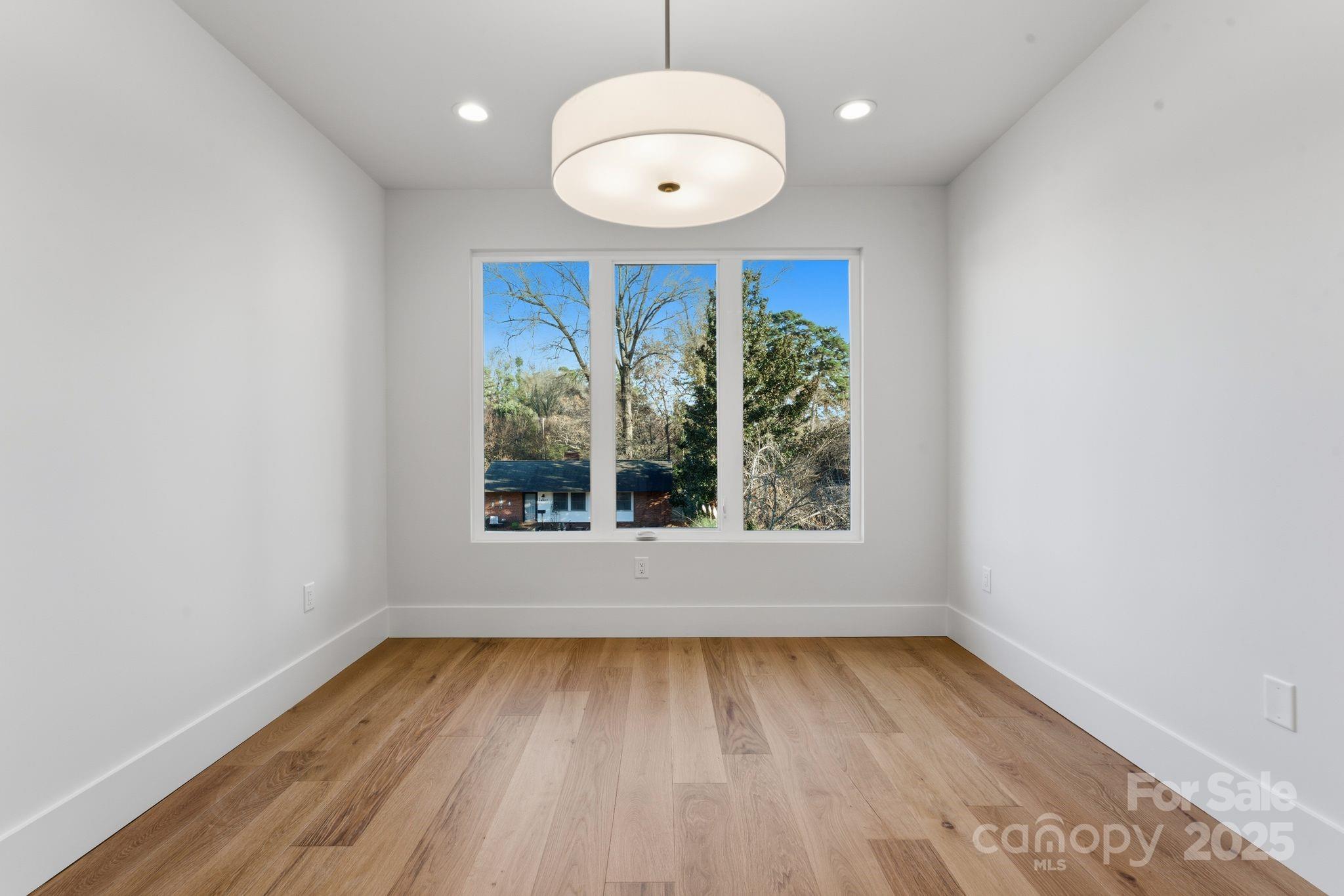 4658 Murrayhill Road Charlotte, NC 28209 - Photo 37 of 48 an empty room with wooden floor and windows