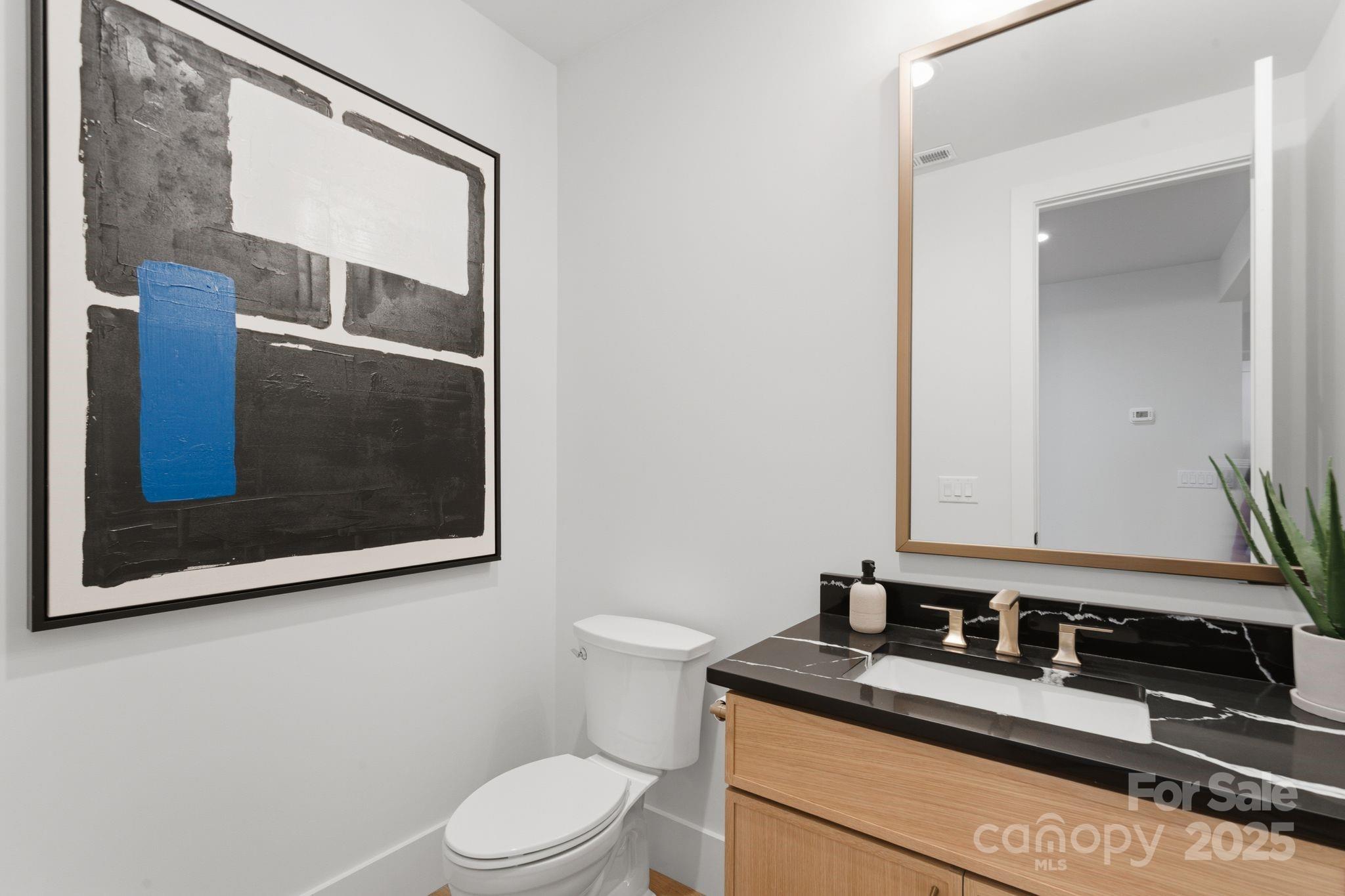 4658 Murrayhill Road Charlotte, NC 28209 - Photo 6 of 48 a bathroom with a granite countertop sink toilet and mirror