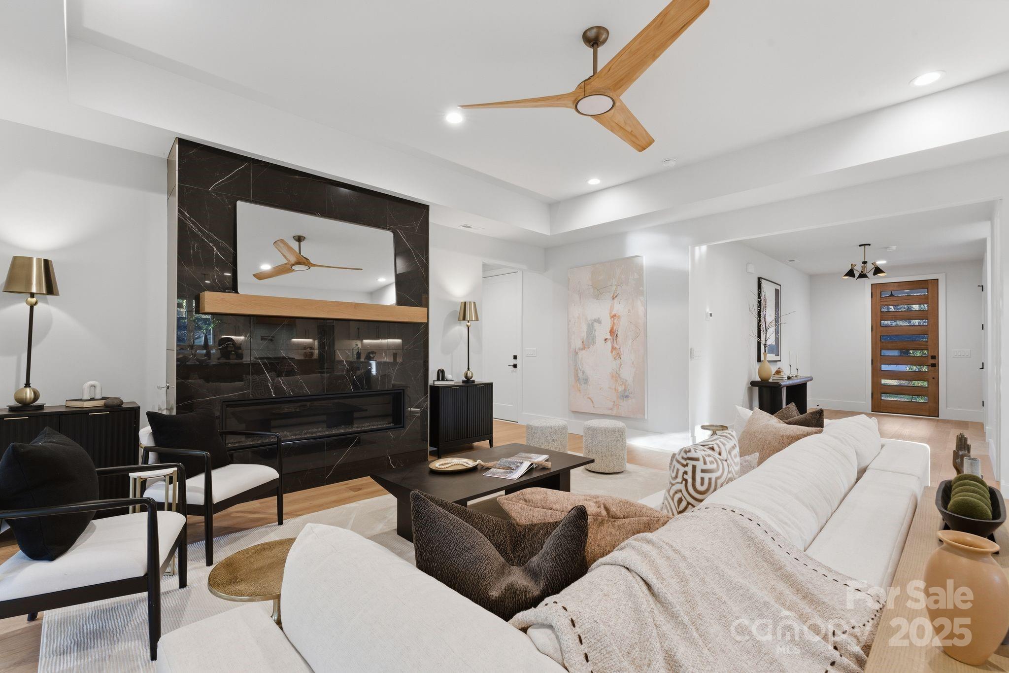 4658 Murrayhill Road Charlotte, NC 28209 - Photo 7 of 48 a living room with furniture a flat screen tv and a fireplace