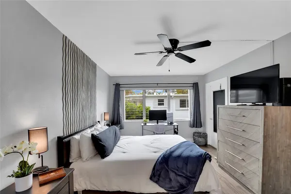 a bed room with furniture and a flat screen tv