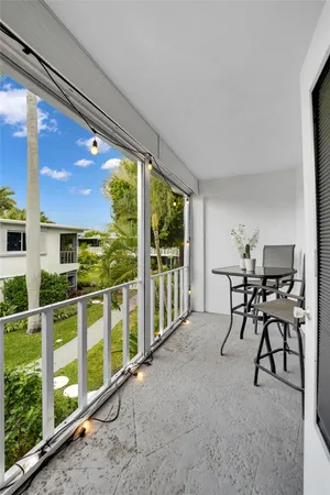 a view of a porch with furniture and yard