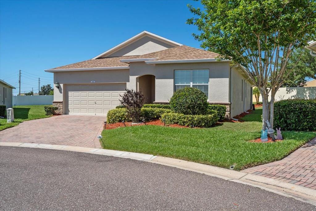 3565 Raleigh Drive Winter Haven, FL 33884 - Photo 2 of 73 a front view of a house with a yard and garage