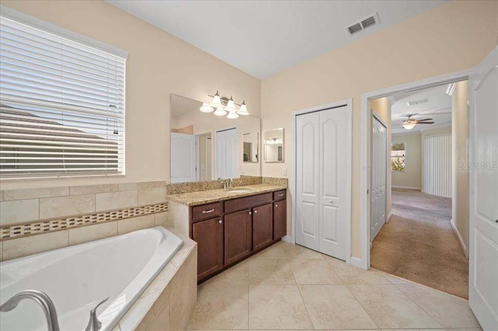 3565 Raleigh Drive Winter Haven, FL 33884 - Photo 25 of 73 a bathroom with a tub a sink and a mirror