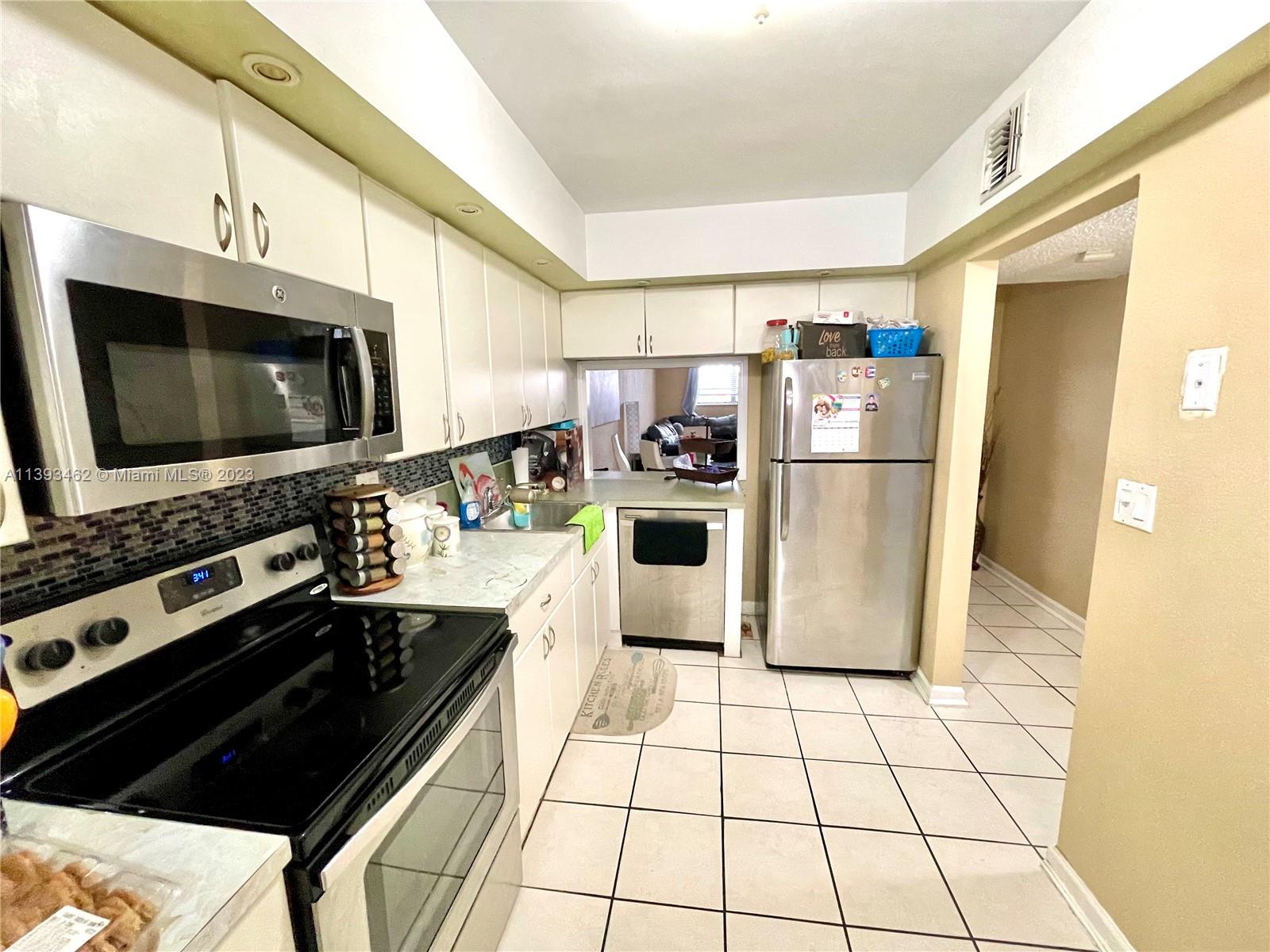 a kitchen with stainless steel appliances a refrigerator a stove a microwave and cabinets