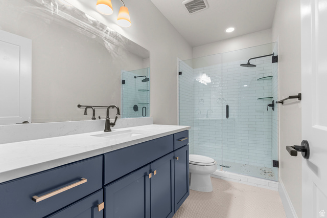 11718 South Halls Crk Road Draper, UT 84020 - Photo 26 of 28 Bathroom featuring a large vanity with a white countertop and blue cabinetry, a rectangular undermount sink, and a dark bronze faucet